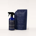 SOHJI Glass & Mirror Set: Glass & Mirror Cleaner cobalt glass spray bottle next to its navy 32 fl oz refill pouch